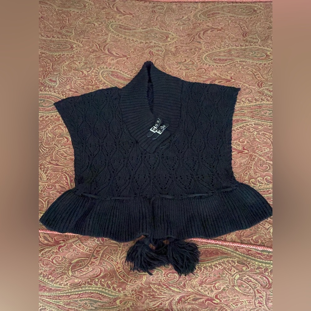 Black pull over vest with decorative buckle and waist pull string